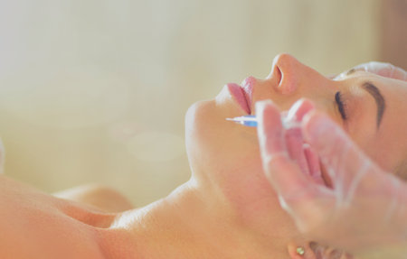 Beautiful woman gets beauty facial injections. Face aging injection. Aesthetic Cosmetologyの写真素材