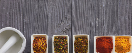 Various spices in a bowls on gray backgroundの写真素材