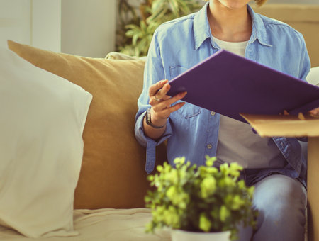 Young woman moving out and packing cardboard boxの写真素材