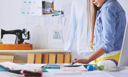 Fashion designer working on her designs in the studioの写真素材