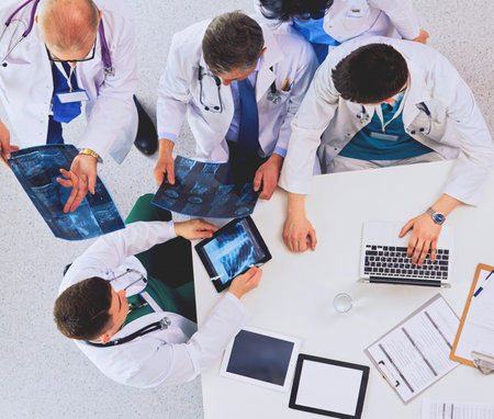 Medical team sitting and discussing at table, top viewの写真素材