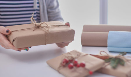 Hands of woman holding christmas gift box.