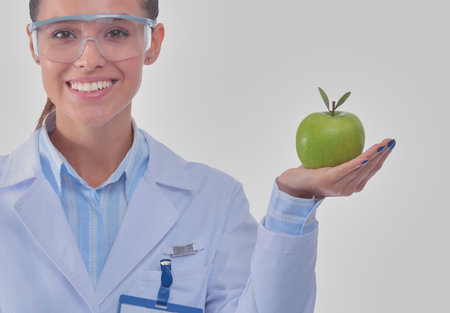 Smiling woman doctor with a green apple. Woman doctorの写真素材