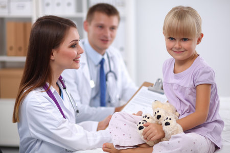 Little girl and young doctor in hospital having examinationの写真素材