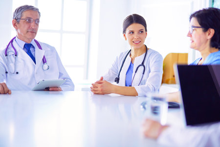 Serious medical team discussing patients case in a bright officeの写真素材