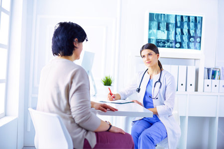 Medical consultation in a hospital. Doctor listening to a patients problemsの写真素材
