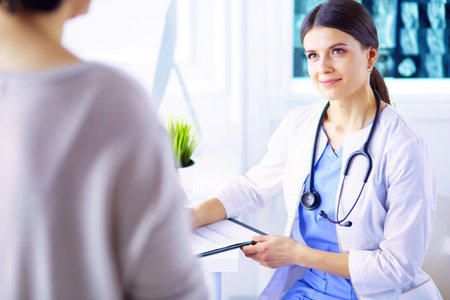 Medical consultation in a hospital. Doctor listening to a patients problemsの写真素材