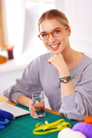 Fashion designer woman working on her designs in the studioの写真素材