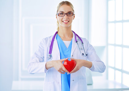 healthcare and medical concept - female doctor with heartの写真素材