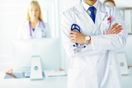 Young male doctor in front of medical groupの写真素材