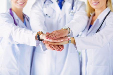 Doctors and nurses in a medical team stacking handsの写真素材