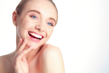 Portrait of beautiful woman with natural make up touching her face.の写真素材