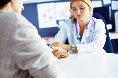 Woman doctor helping senior holding hand in hospitalの写真素材