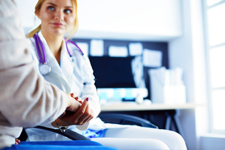 Doctor or nurse holding elderly ladys handsの写真素材