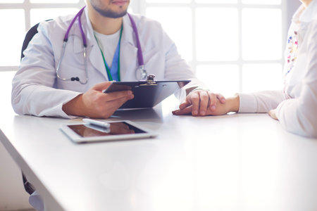 male doctor comforting patient who is in ambulanceの写真素材