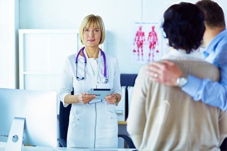 Medical doctor and young couple patients in hospitalの写真素材