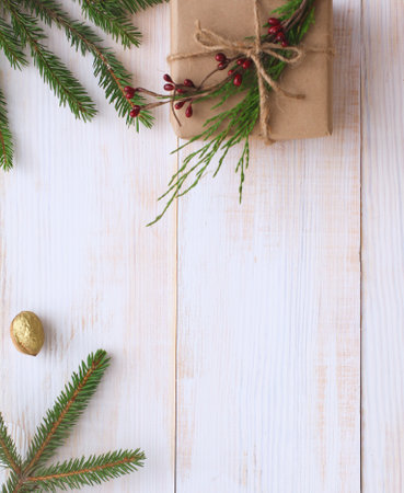 Christmas gift boxes and fir tree branch on wooden table, flat lay. Ð¡hristmas backgroundの写真素材