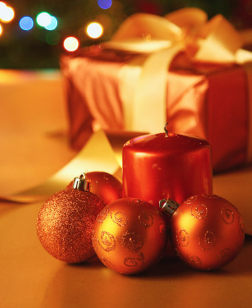 Christmas card with gift, candle Christmas balls. Lighting christmas tree on a background.の写真素材