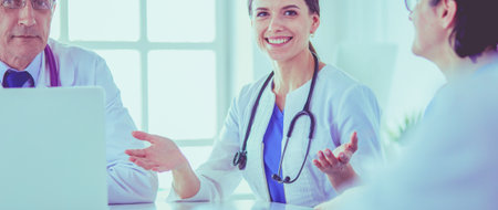 Serious medical team discussing patients case in a bright officeの写真素材
