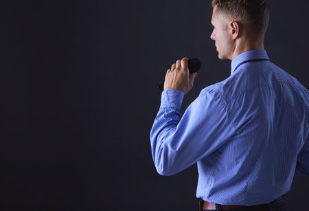 Businessman speech concept, talking with microphone in conference hallの写真素材