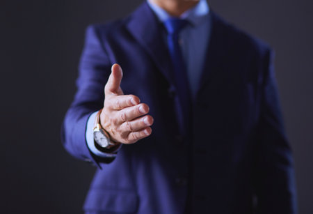 Portrait of a businessman standing with a microphone and looking ahead, speak at the conferenceの写真素材