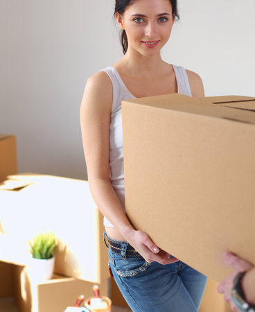 Happy young couple unpacking or packing boxes and moving into a new home. young coupleの写真素材