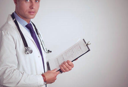 Male doctor standing with folder, isolated on white backgroundの写真素材