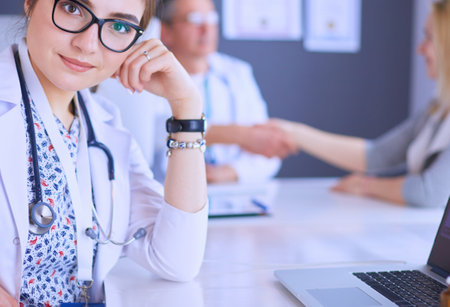 Doctor and patient discussing something while sitting at the table . Medicine and health care conceptの写真素材