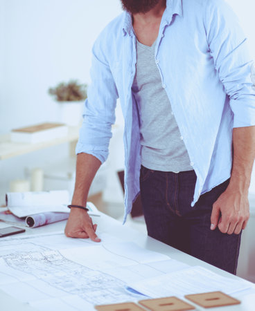 Designer in office working on project with laptopの写真素材