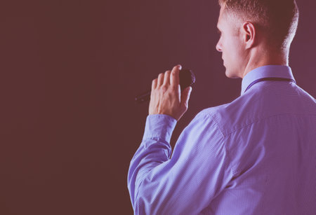 Businessman speech concept, talking with microphone in conference hallの写真素材
