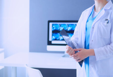Portrait of doctor with tablet in hands at hospital.の写真素材