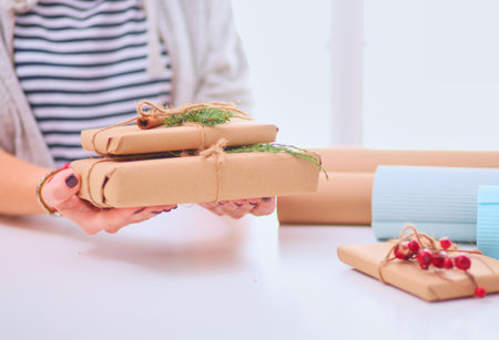 Hands of woman holding christmas gift box.の写真素材