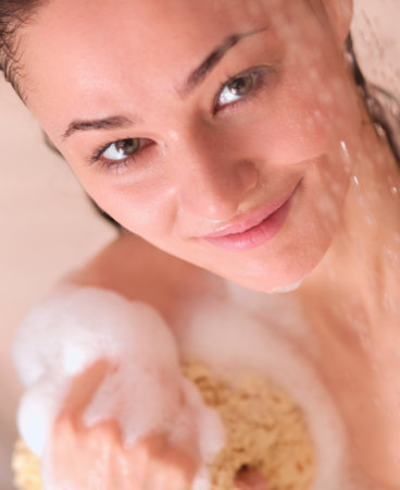 Young beautyful woman under shower in bathroom.の写真素材