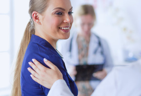 Doctor and patient discussing something while sitting at the table . Medicine and health care conceptの写真素材