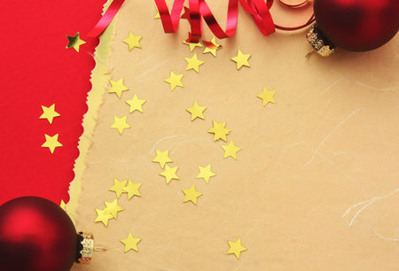 Christmas background or xmas greeting card. Red cristmas balls and decorations on red table. Top view with copy space.の写真素材