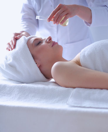Young woman lying on a massage table,relaxing with eyes closed. Woman. Spa salonの写真素材