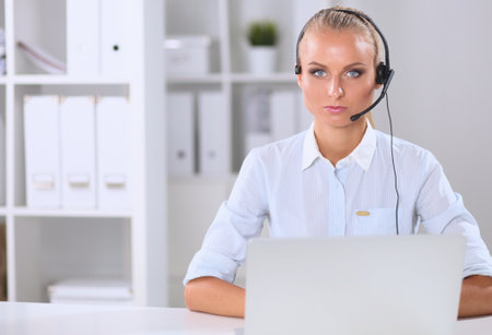 Close-up portrait of a customer service agent sitting at officeの写真素材