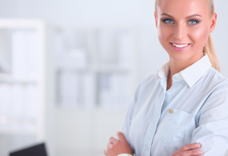 Portrait of beautiful smiling women in white style at the office.の写真素材
