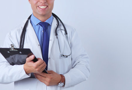 Male doctor standing with folder, isolated on white backgroundの写真素材
