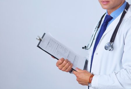 Male doctor standing with folder, isolated on white backgroundの写真素材