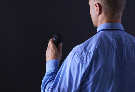 Businessman speech concept, talking with microphone in conference hallの写真素材