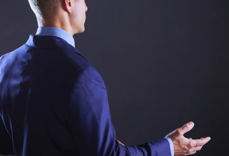 Portrait of a businessman standing with a microphone and looking ahead, speak at the conferenceの写真素材