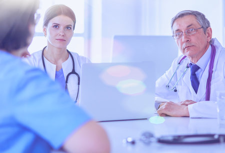 Serious medical team working in a bright officeの写真素材