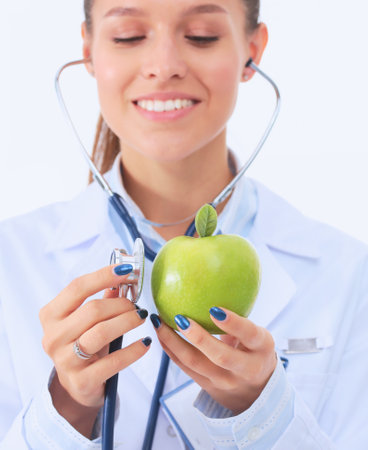 Medical doctor woman examining apple with stethoscope. Woman doctorsの写真素材
