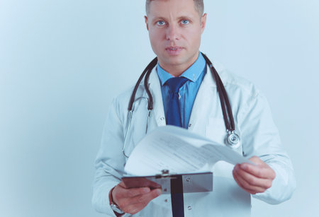 Male doctor standing with folder, isolated on white backgroundの写真素材
