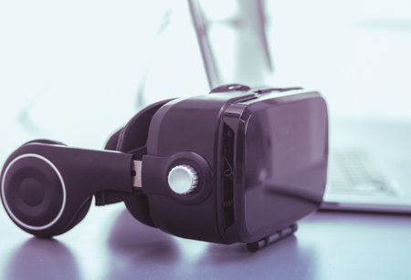 Virtual reality goggles on desk with laptop. business. 3d technologyの写真素材