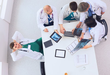 Medical team sitting and discussing at table, top viewの写真素材