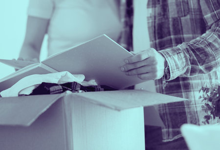 A just married couple unpacking boxes and moving into a new home. Positive emotion.の写真素材