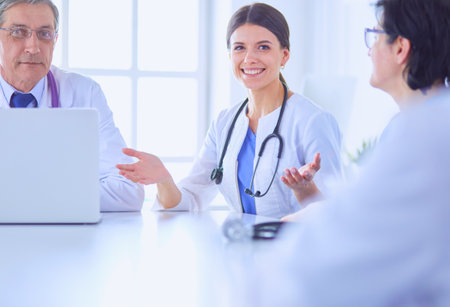 Serious medical team discussing patients case in a bright officeの写真素材