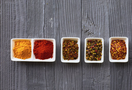 Various spices in a bowls on gray backgroundの写真素材